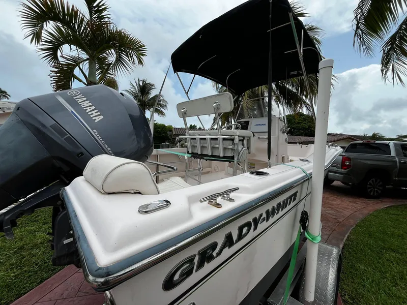 Slide: The Image of 2013 Grady-White Fisherman 180 boat with Yamaha engine, parked near palm trees. - 20