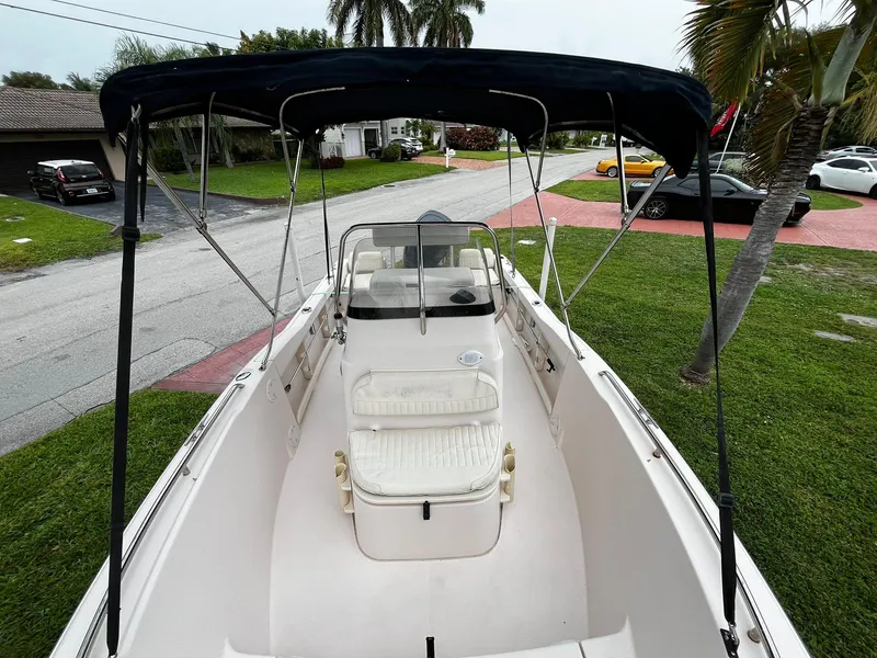 Slide: The Image of 2013 Grady-White Fisherman 180 boat with canopy, parked on grass near residential area. - 21