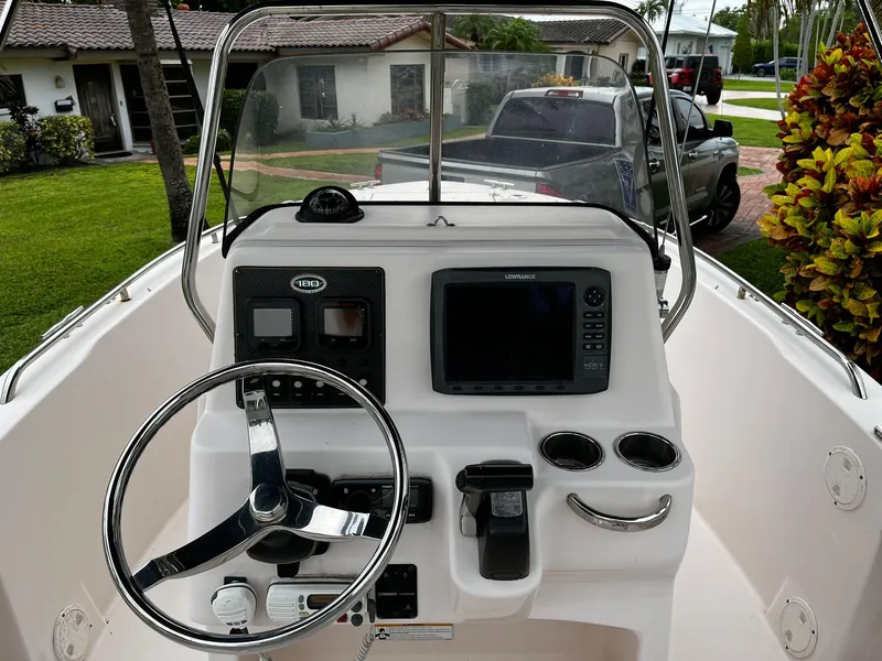 Slide: The Image of 2013 Grady-White Fisherman 180 boat dashboard with steering wheel and navigation equipment. - 22