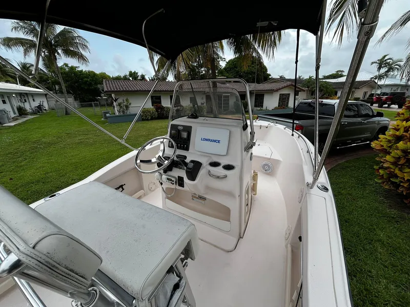 Slide: The Image of 2013 Grady-White Fisherman 180 boat with steering console, parked in a residential yard. - 24