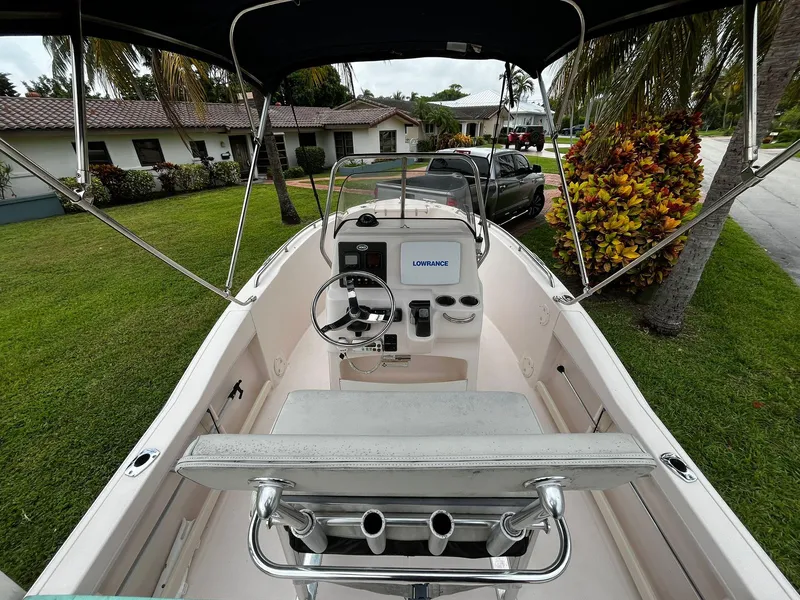 Slide: The Image of 2013 Grady-White Fisherman 180 boat with steering console, parked in a residential area. - 25