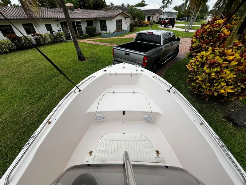 Slide: The Image of 2013 Grady-White Fisherman 180 boat parked in a residential driveway with a pickup truck nearby. - 28