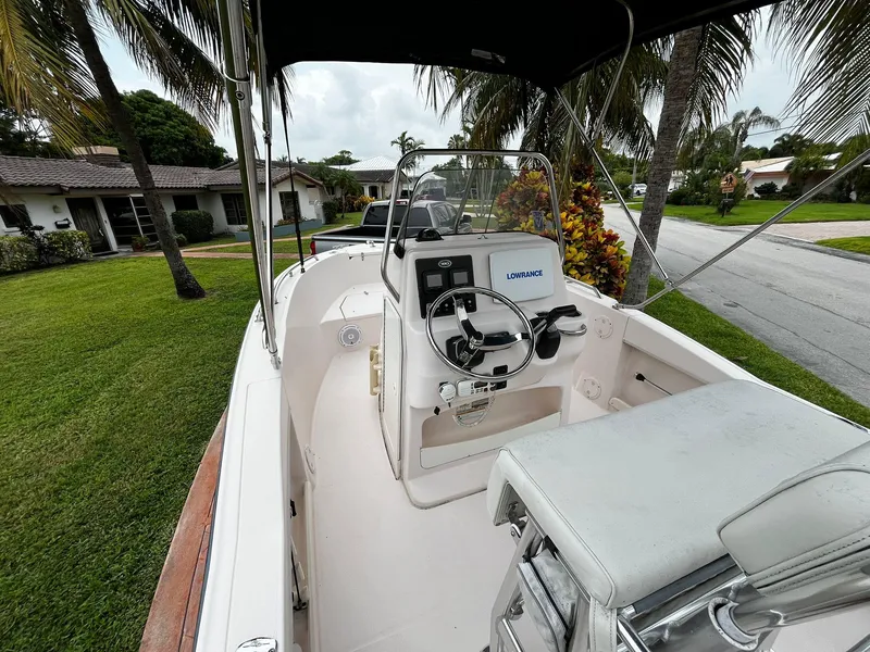 Slide: The Image of 2013 Grady-White Fisherman 180 boat interior with steering console, parked in a residential area. - 29