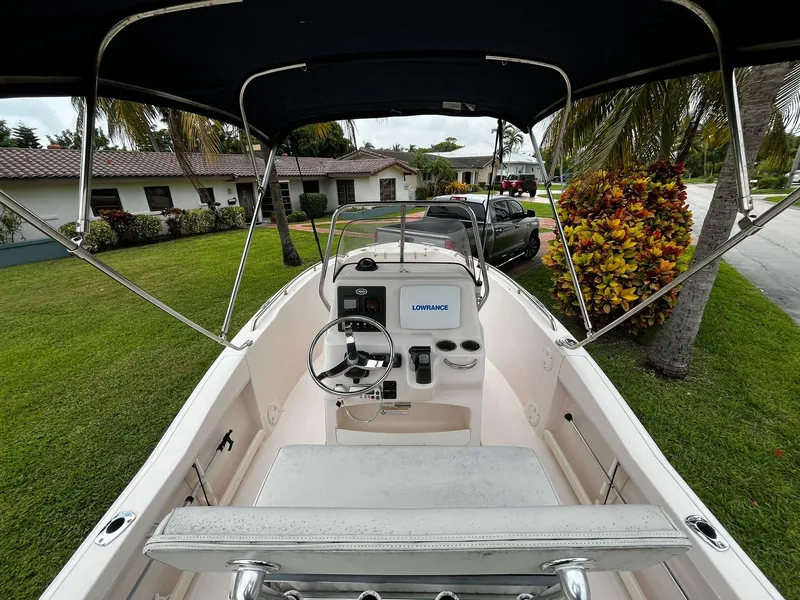 Slide: The Image of 2013 Grady-White Fisherman 180 boat with canopy, parked in a residential area. - 30