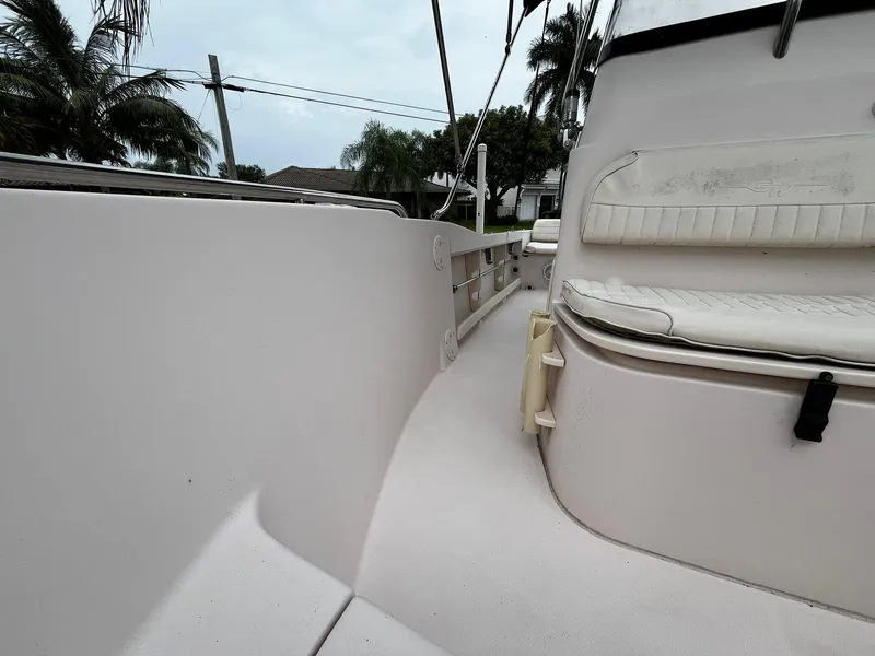 Slide: The Image of 2013 Grady-White Fisherman 180 boat interior with seating and railing, surrounded by palm trees. - 32