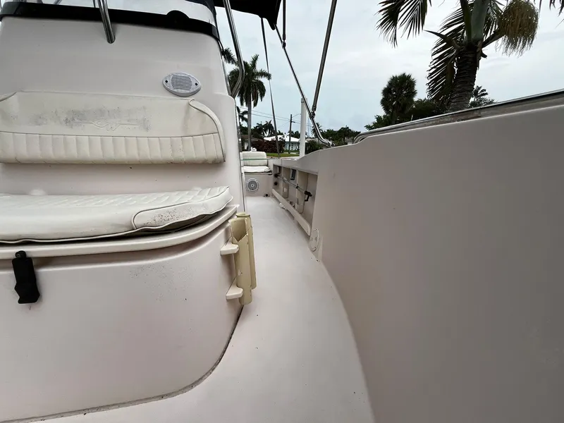 Slide: The Image of 2013 Grady-White Fisherman 180 boat interior with seating and palm trees in the background. - 34