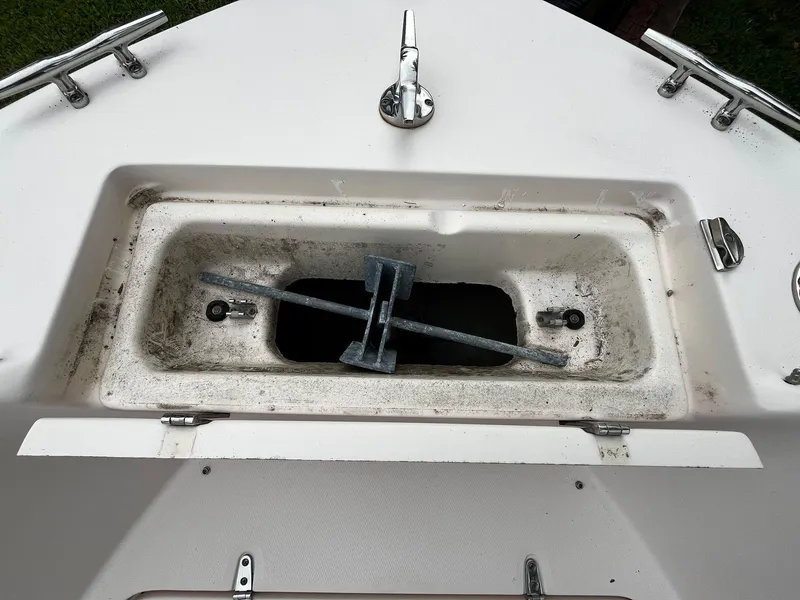 Slide: The Image of 2013 Grady-White Fisherman 180 boat anchor compartment with open hatch and visible anchor. - 38