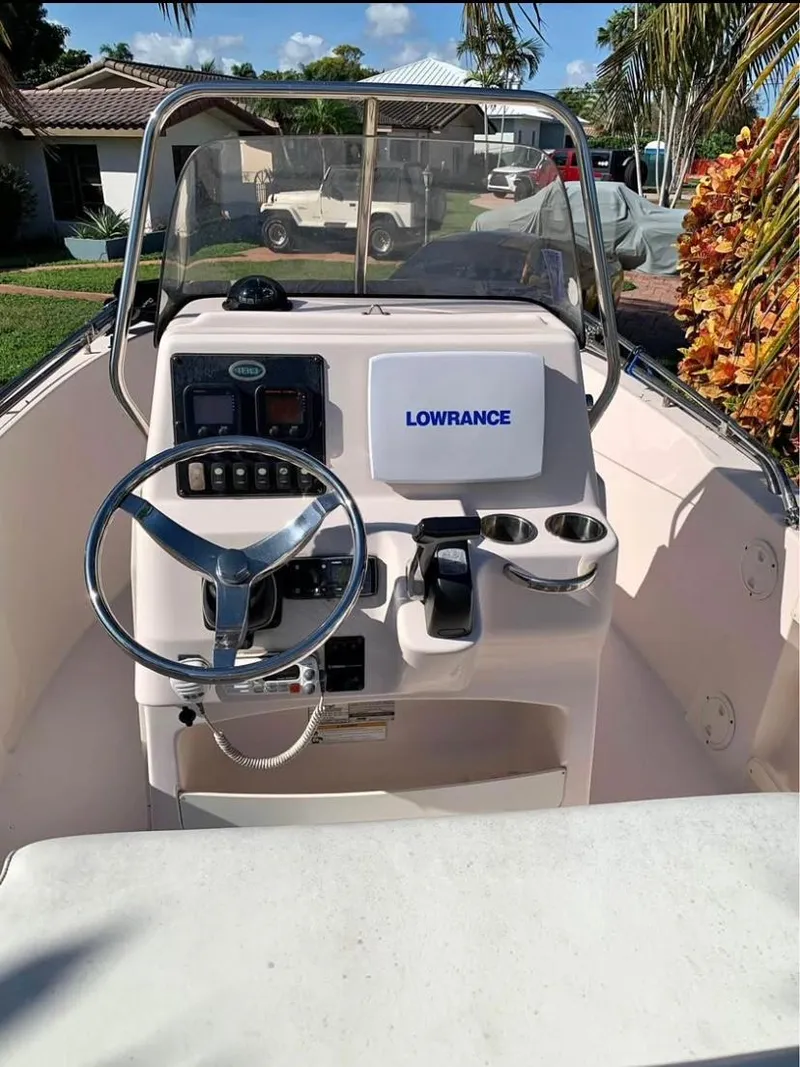 Slide: The Image of 2013 Grady-White Fisherman 180 boat dashboard with steering wheel and Lowrance equipment. - 39