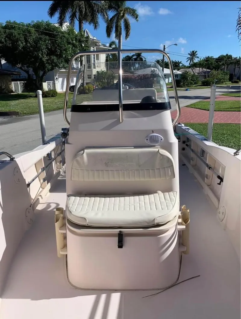 Slide: The Image of 2013 Grady-White Fisherman 180 boat interior with seating, parked in a sunny residential area. - 40