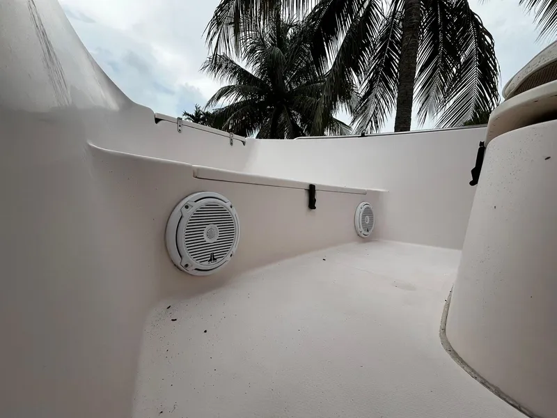Slide: The Image of 2013 Grady-White Fisherman 180 boat interior with speakers, palm trees in background. - 41