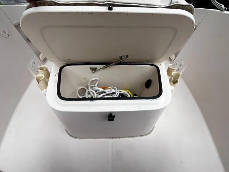 Slide: The Image of Open storage compartment on 2013 Grady-White Fisherman 180 boat, containing rope and tools. - 43