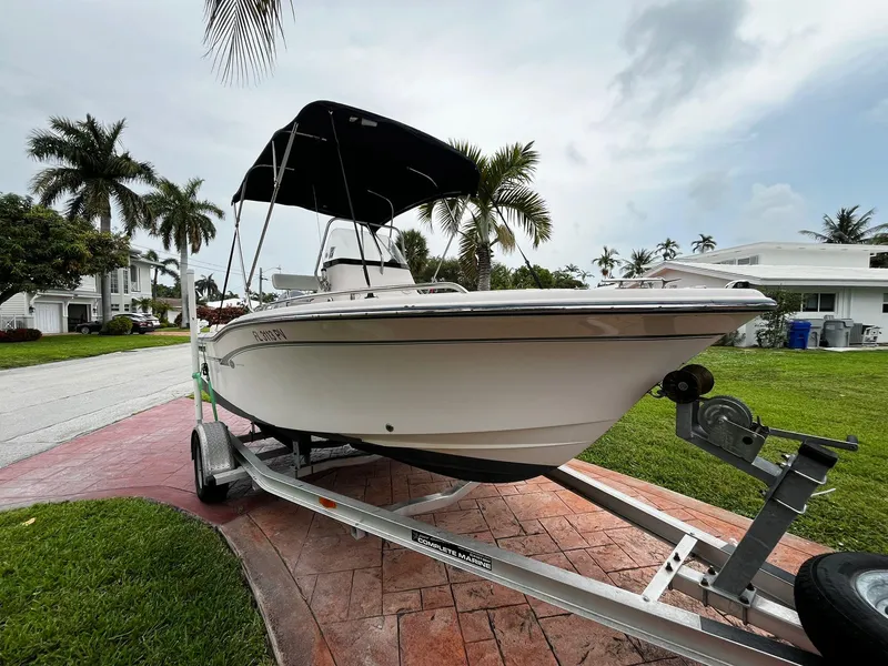 Slide: The Image of 2013 Grady-White Fisherman 180 boat on trailer, parked in a tropical residential area. - 5