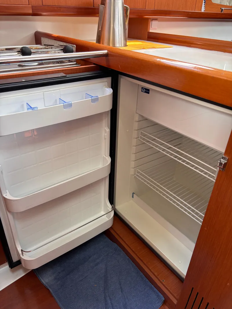 Slide: The Image of Beneteau Oceanis 34 yacht kitchen with open fridge, 2009 model. - 10