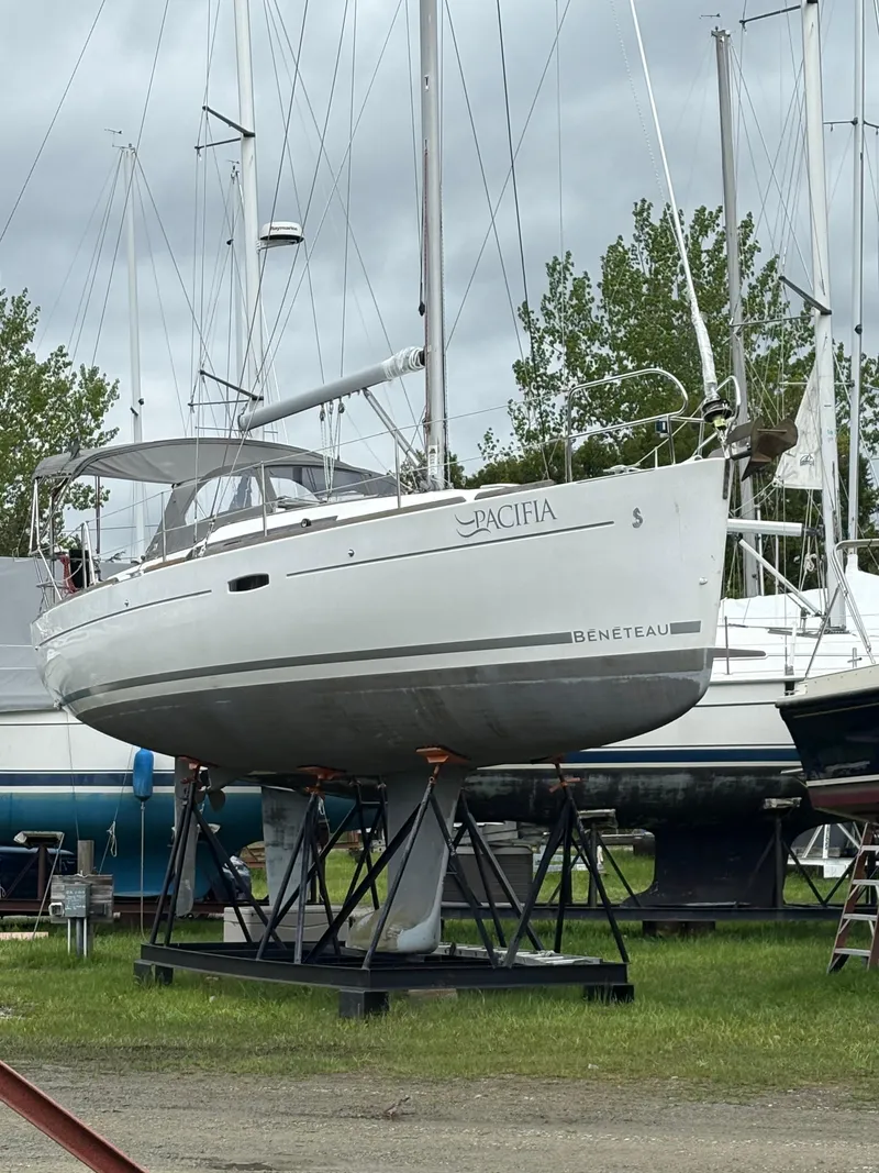 Slide: The Image of 2009 Beneteau Oceanis 34 sailboat on stands, displayed outdoors. - 2