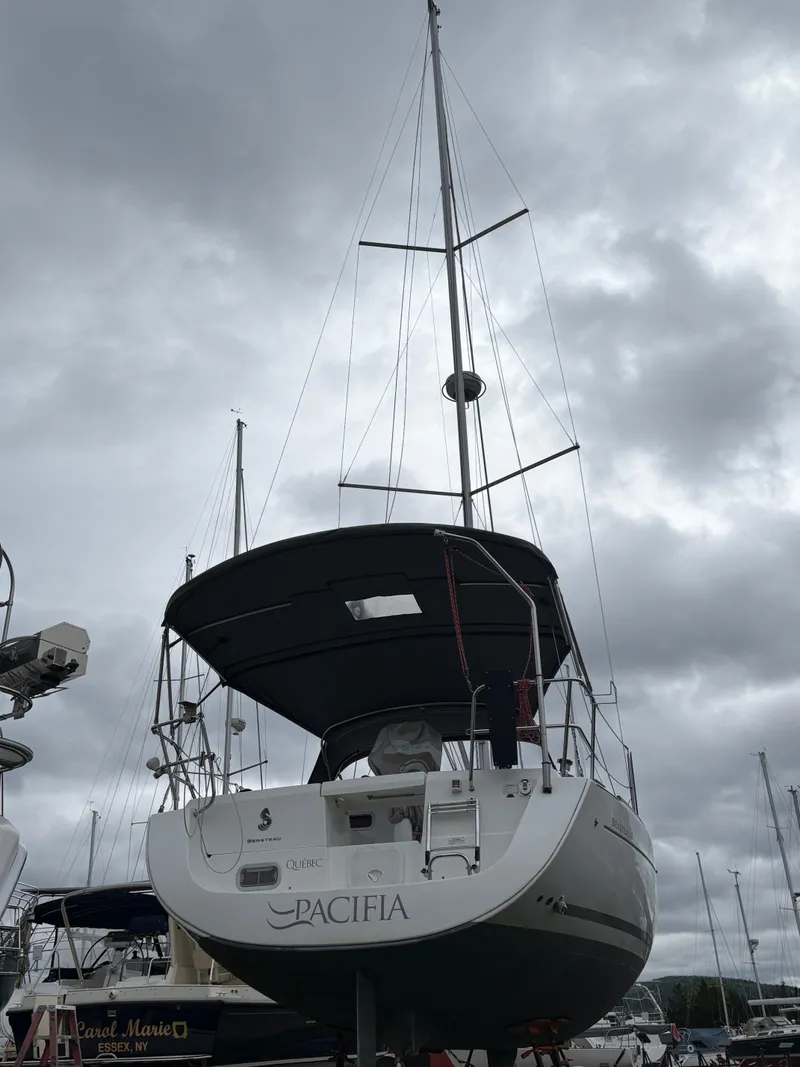 Slide: The Image of 2009 Beneteau Oceanis 34 sailboat docked under cloudy skies. - 4