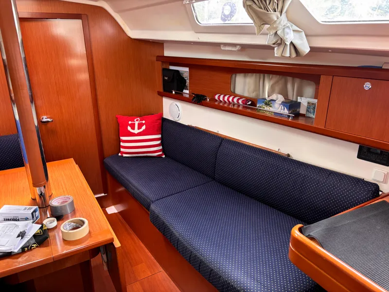 Slide: The Image of Interior of 2009 Beneteau Oceanis 34 sailboat with cozy seating and nautical decor. - 7