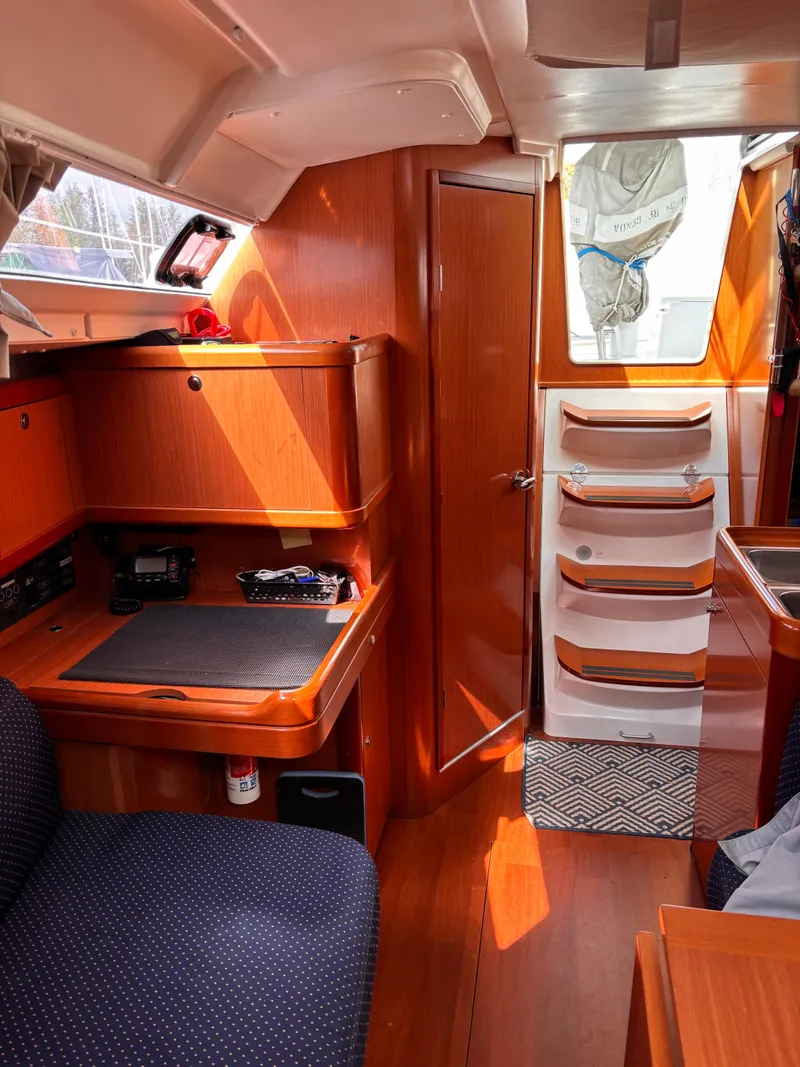 Slide: The Image of Interior of 2009 Beneteau Oceanis 34 sailboat with wooden cabinetry and seating area. - 8