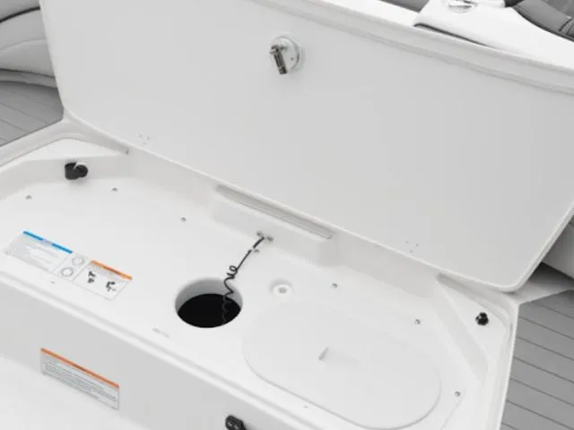 Slide: The Image of 2025 Yamaha Boats SX190 storage compartment with open lid and visible interior features. - 25