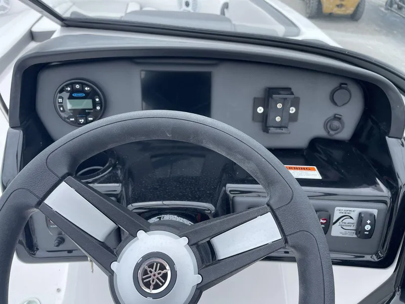 Slide: The Image of Dashboard of 2025 Yamaha Boats SX190 with steering wheel and control panel. - 28