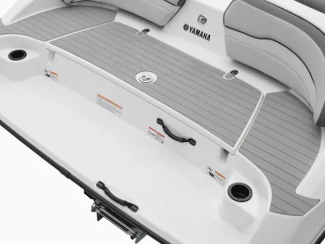 Slide: The Image of 2025 Yamaha Boats SX190 swim platform with gray decking and cup holders. - 2