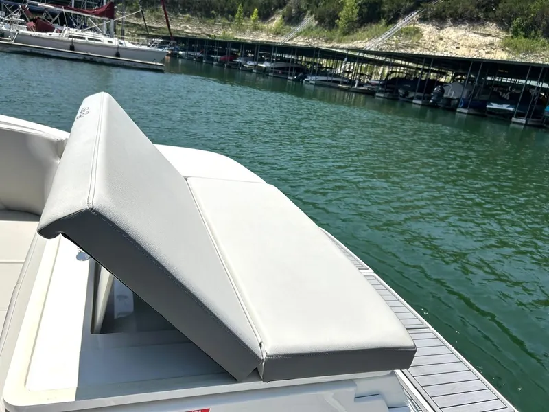 Slide: The Image of 2020 Sea Ray SPX 230 boat with adjustable seating, docked on a serene lake. - 21