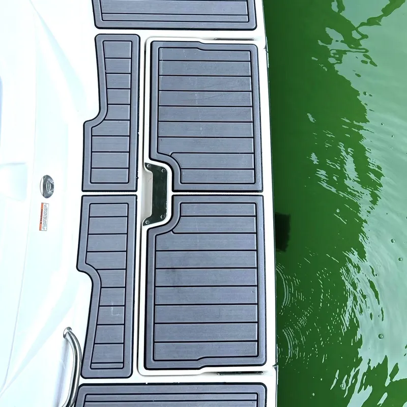 Slide: The Image of 2020 Sea Ray SPX 230 swim platform with textured black matting on green water. - 22