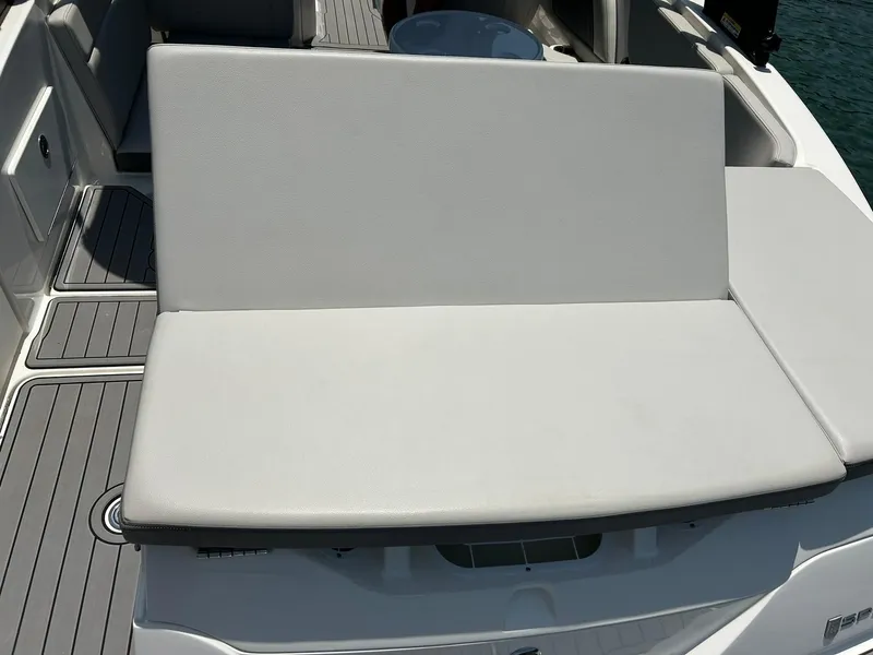 Slide: The Image of 2020 Sea Ray SPX 230 boat seating area with gray upholstery. - 24