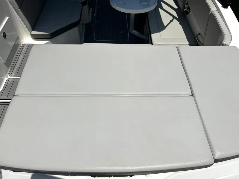 Slide: The Image of 2020 Sea Ray SPX 230 boat interior with cushioned seating and table. - 27