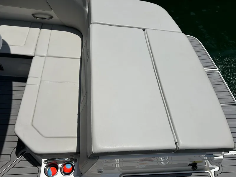 Slide: The Image of 2020 Sea Ray SPX 230 boat seating area with white cushions and deck details. - 28