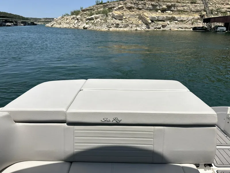 Slide: The Image of 2020 Sea Ray SPX 230 boat on a lake with rocky shoreline in the background. - 29