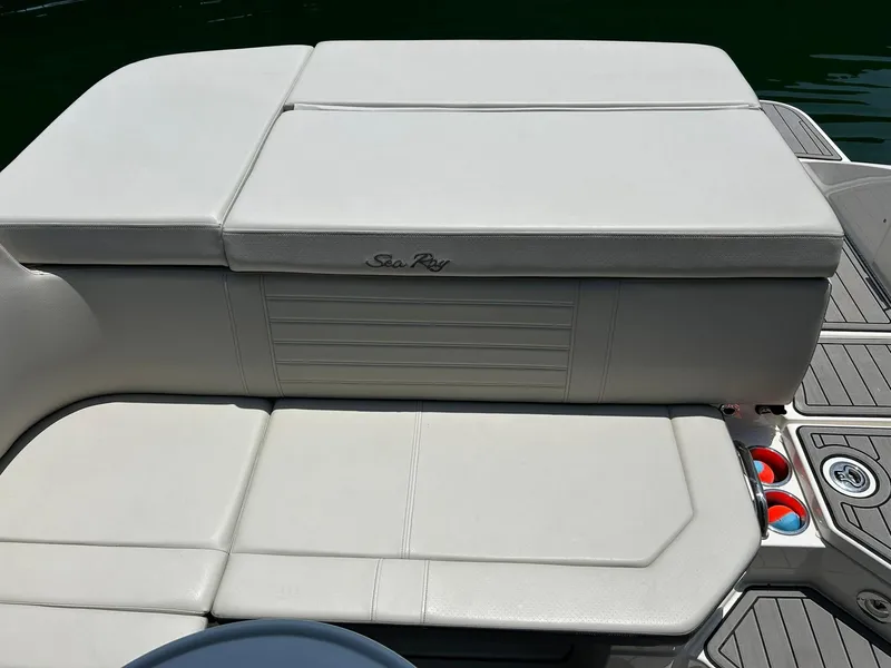 Slide: The Image of 2020 Sea Ray SPX 230 boat seating area with cup holders and sleek design. - 30