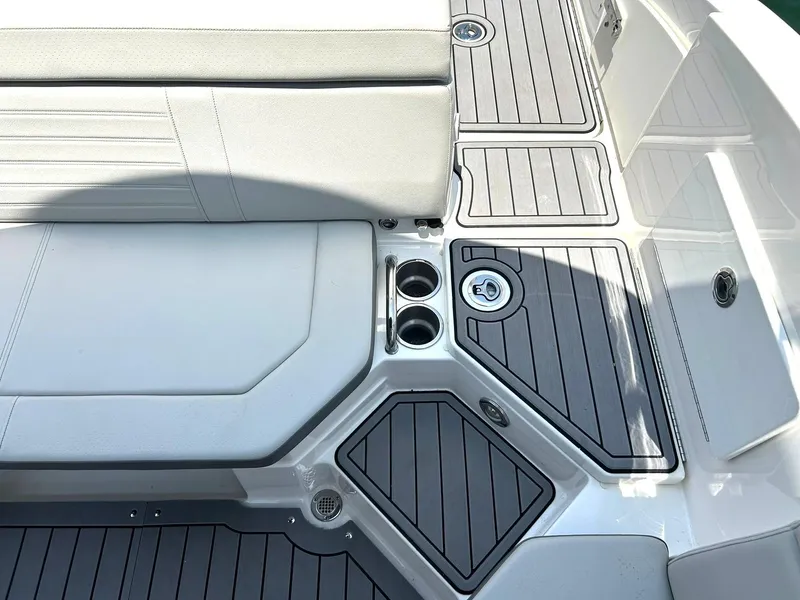 Slide: The Image of 2020 Sea Ray SPX 230 boat deck with seating and cup holders. - 31