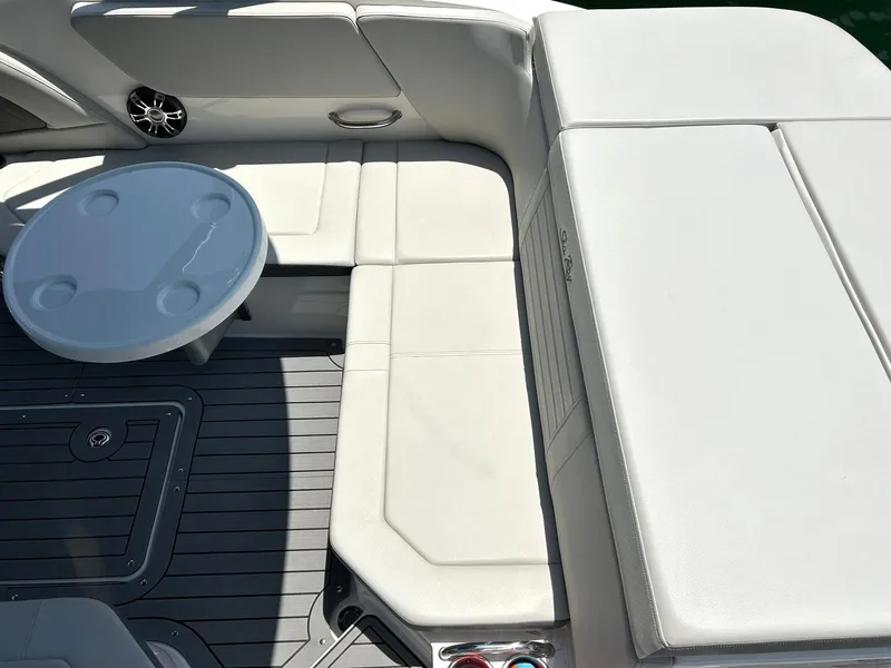 Slide: The Image of 2020 Sea Ray SPX 230 boat interior with white seating and round table. - 32