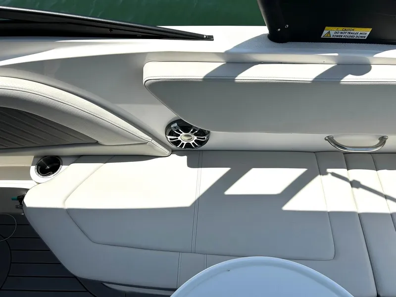 Slide: The Image of 2020 Sea Ray SPX 230 boat interior with white seating and speaker. - 33