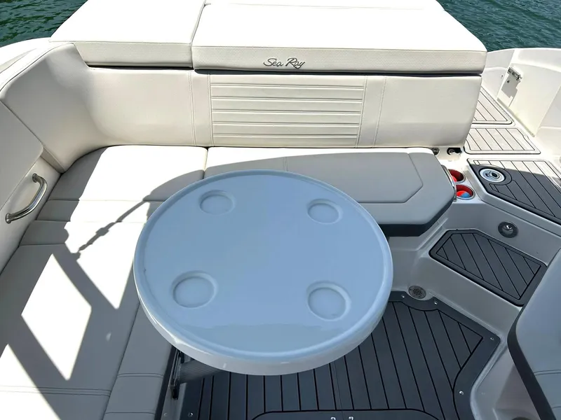 Slide: The Image of 2020 Sea Ray SPX 230 boat interior with seating and round table on deck. - 34
