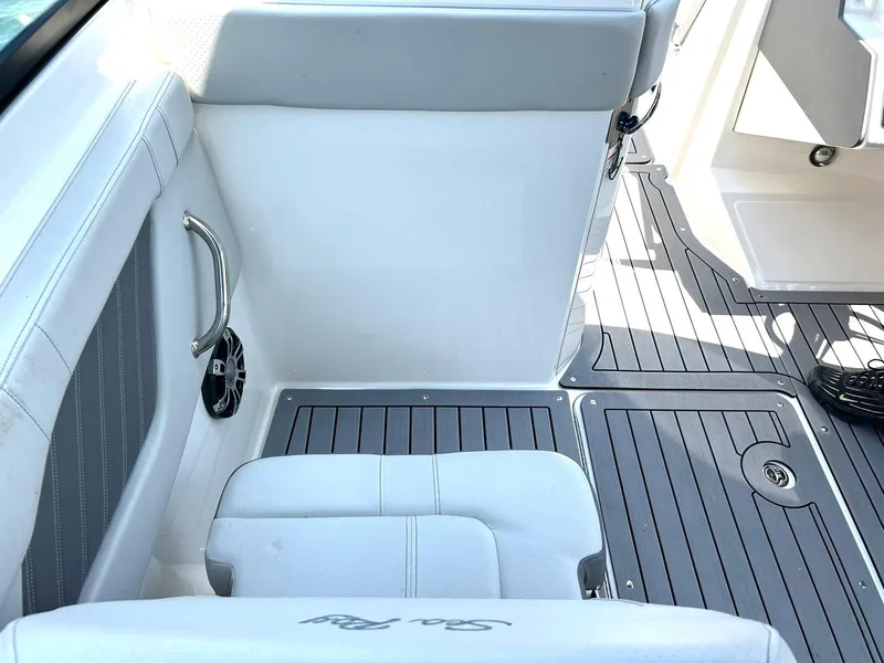 Slide: The Image of 2020 Sea Ray SPX 230 boat interior with white seating and gray flooring. - 37