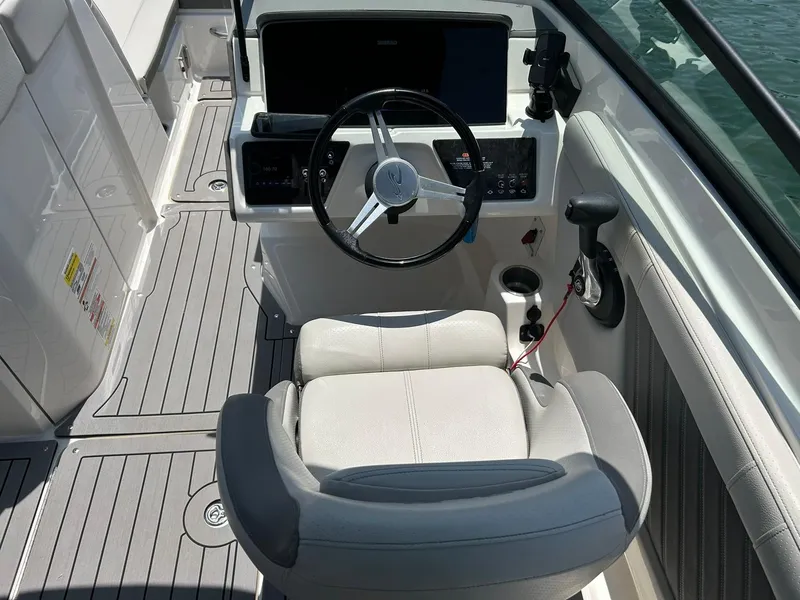 Slide: The Image of 2020 Sea Ray SPX 230 boat cockpit with steering wheel and seating. - 40