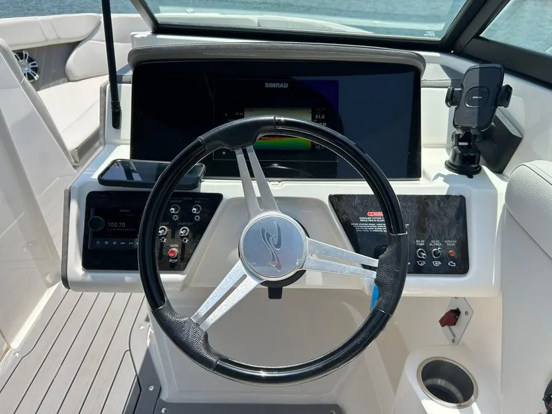 Slide: The Image of Steering wheel and dashboard of 2020 Sea Ray SPX 230 boat, featuring modern controls. - 41