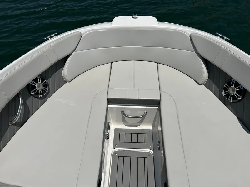 Slide: The Image of 2020 Sea Ray SPX 230 boat interior with cushioned seating and storage compartments. - 47