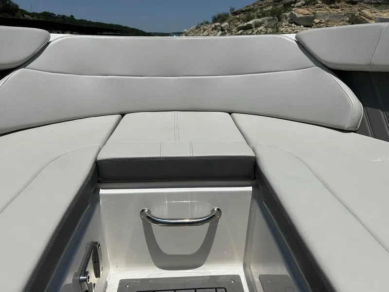 Slide: The Image of 2020 Sea Ray SPX 230 boat interior with cushioned seating and sleek design. - 48