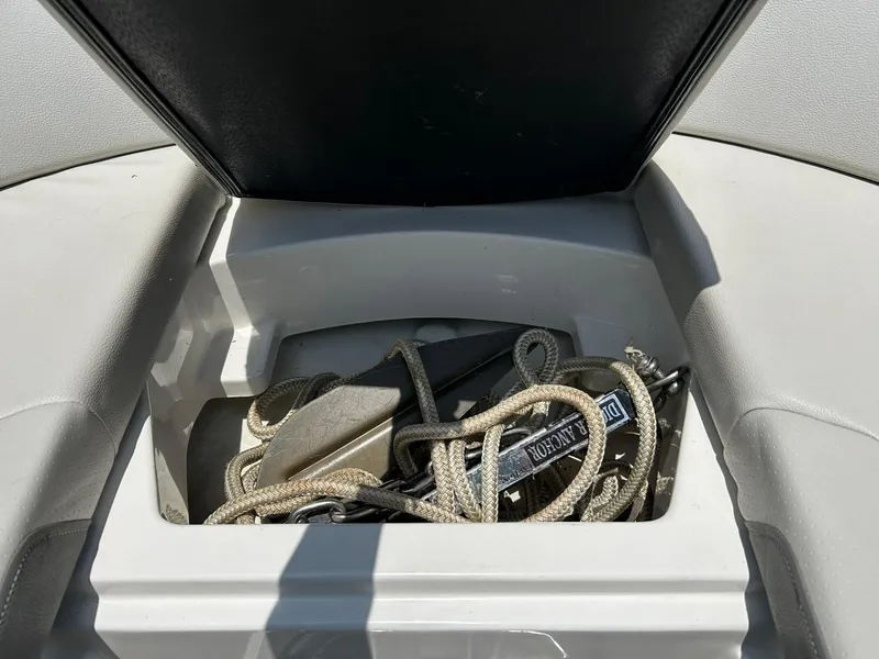 Slide: The Image of Storage compartment on a 2020 Sea Ray SPX 230 boat with ropes and anchor. - 49