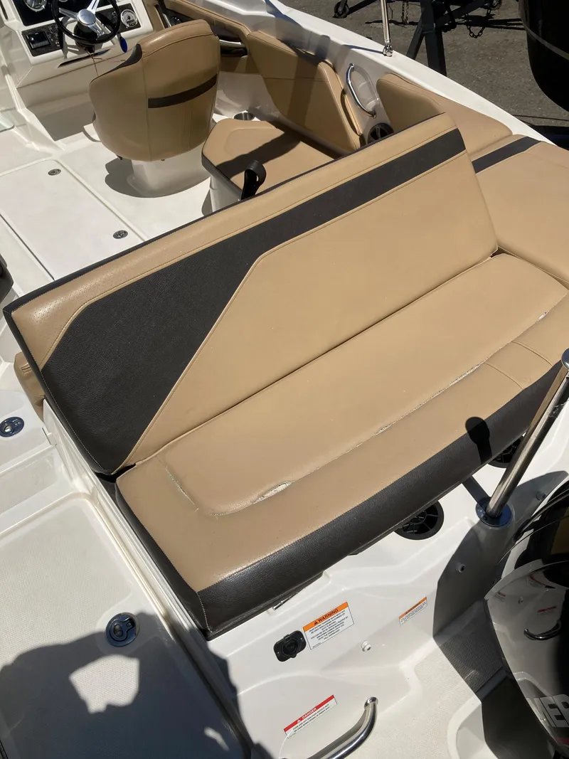 Slide: The Image of 2021 Sea Ray SPX 210 OB boat interior with beige and black seating. - 6