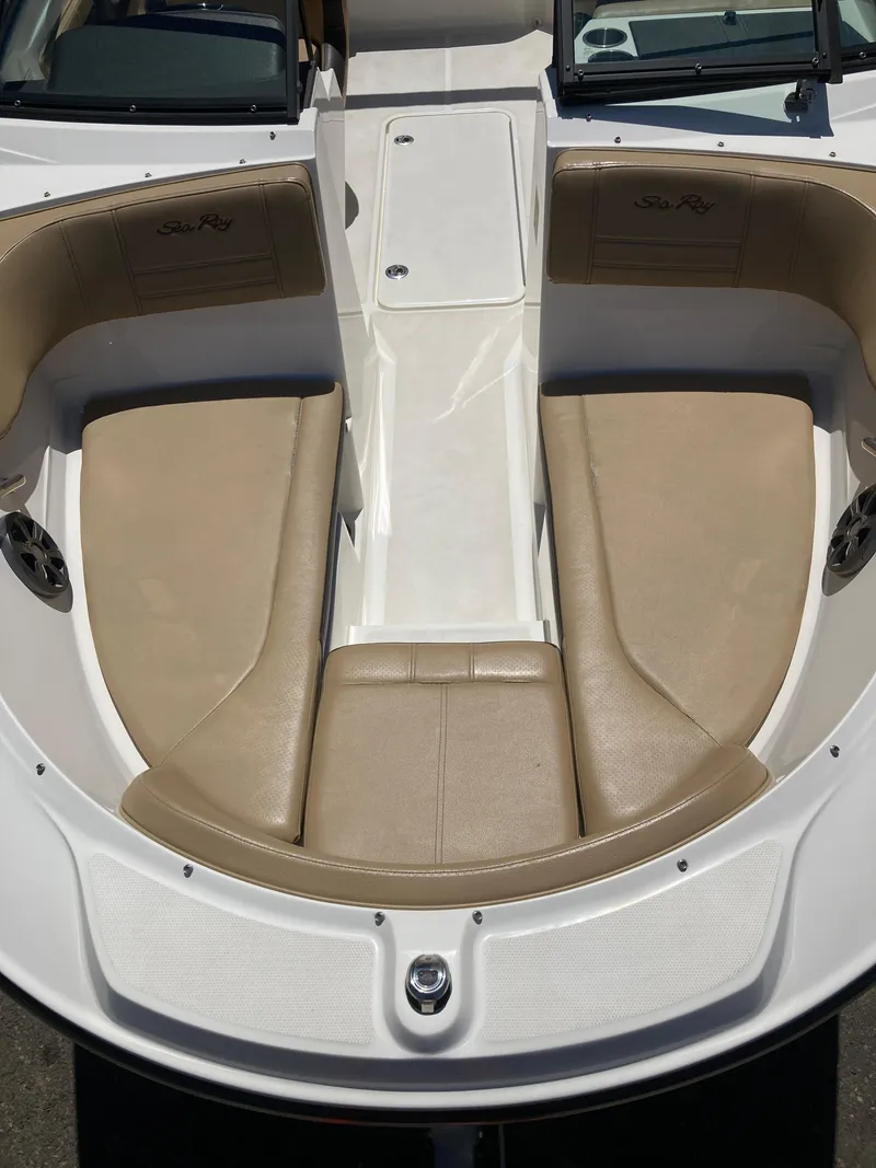 Slide: The Image of 2021 Sea Ray SPX 210 OB boat interior with tan seating and white deck. - 7