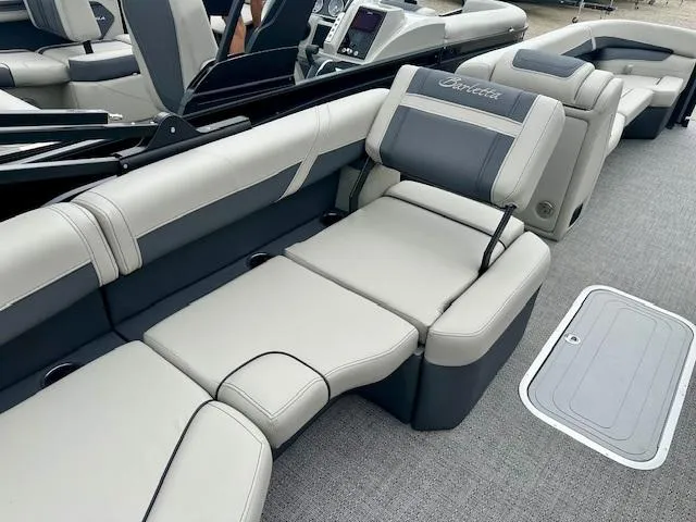 Slide: The Image of 2025 Barletta C24M boat interior with luxurious gray seating and modern dashboard. - 11