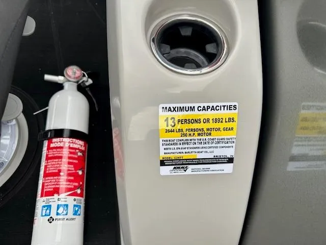 Slide: The Image of Barletta C24M 2025 boat capacity label and fire extinguisher, showing maximum load and safety instructions. - 17
