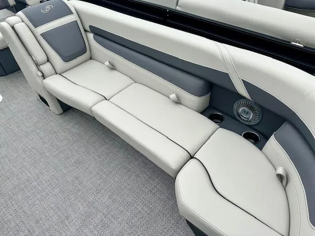 Slide: The Image of 2025 Barletta C24M boat interior with gray and white seating, cup holders, and fan. - 4