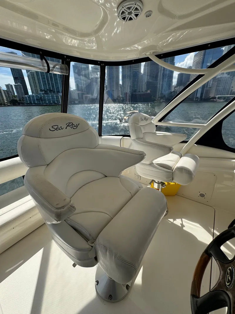 Slide: The Image of 2005 Sea Ray 58 Sedan Bridge helm with luxurious seating and city skyline view. - 21