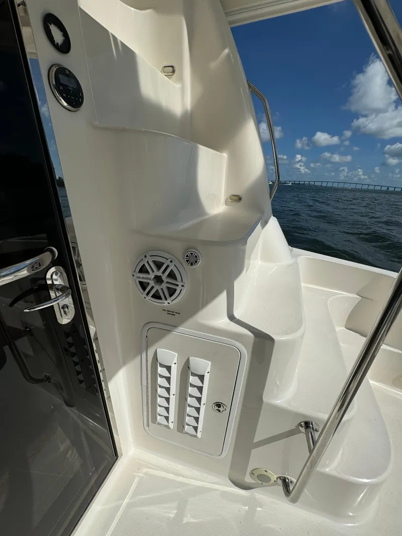 Slide: The Image of 2005 Sea Ray 58 Sedan Bridge yacht interior with ocean view and control panel. - 33