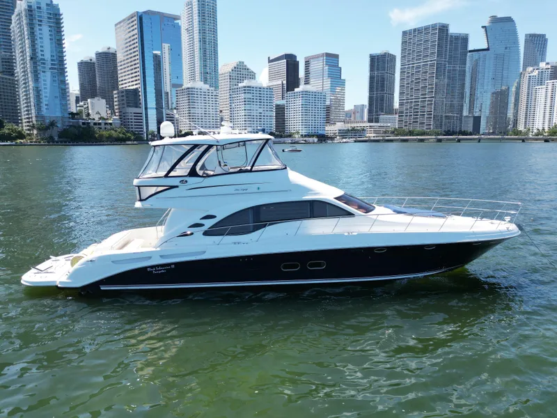 Slide: The Image of 2005 Sea Ray 58 Sedan Bridge yacht cruising near city skyline. - 4