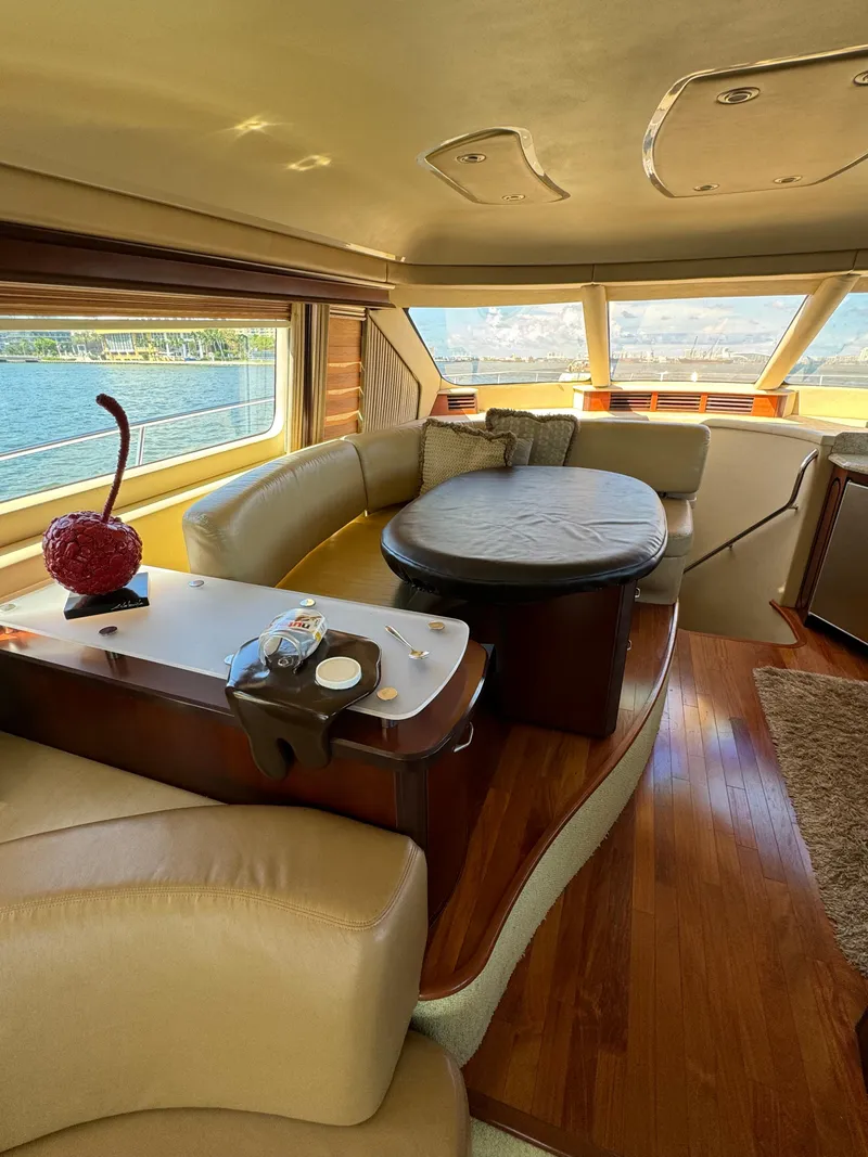 Slide: The Image of Luxurious interior of 2005 Sea Ray 58 Sedan Bridge yacht with elegant seating and panoramic windows. - 40